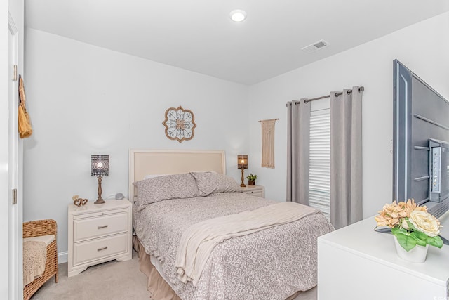 bedroom featuring light carpet and visible vents