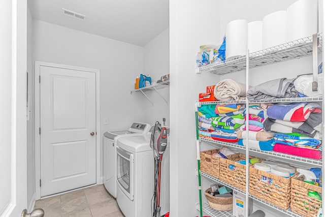 laundry room featuring washing machine and dryer, laundry area, and visible vents