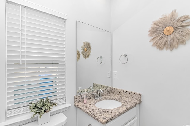 half bath featuring toilet and vanity