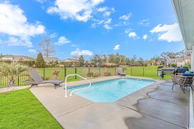 view of swimming pool with a fenced in pool, a yard, fence, and a patio