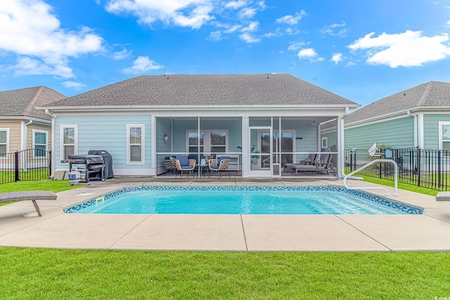 view of swimming pool with a patio area, a grill, fence, and a yard