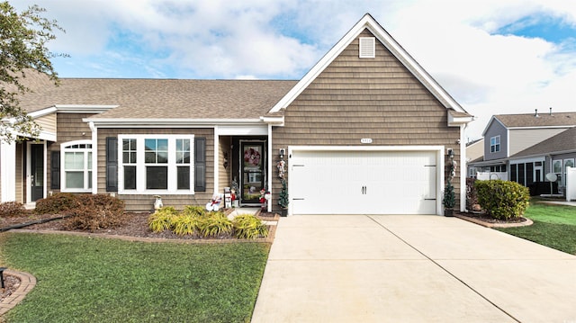 view of front of house featuring a garage and a front lawn