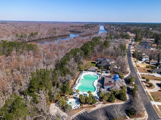 aerial view with a water view and a view of trees