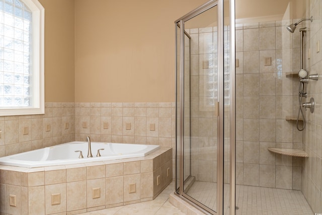 full bathroom featuring a garden tub, a shower stall, and tile patterned flooring