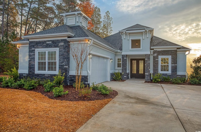 view of front of house with french doors and a garage