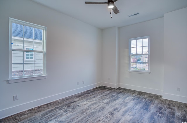 empty room with ceiling fan and dark hardwood / wood-style flooring