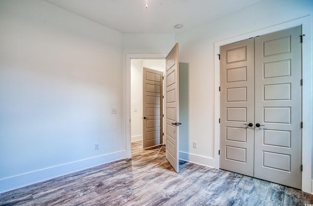 unfurnished bedroom featuring a closet and light hardwood / wood-style flooring