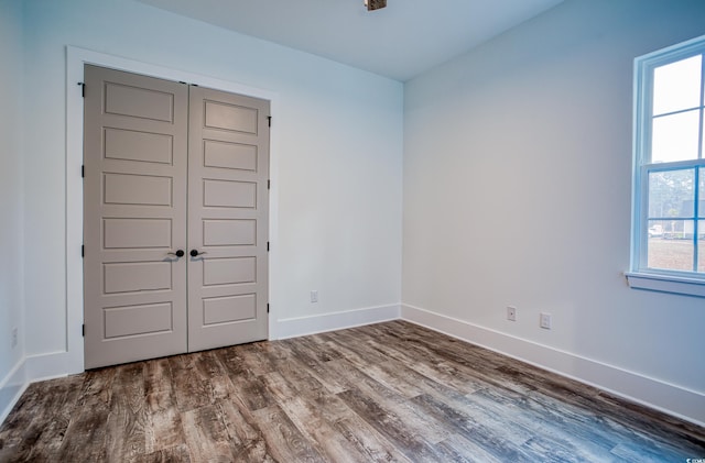 empty room with a healthy amount of sunlight and hardwood / wood-style flooring