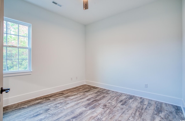 empty room with ceiling fan and wood-type flooring