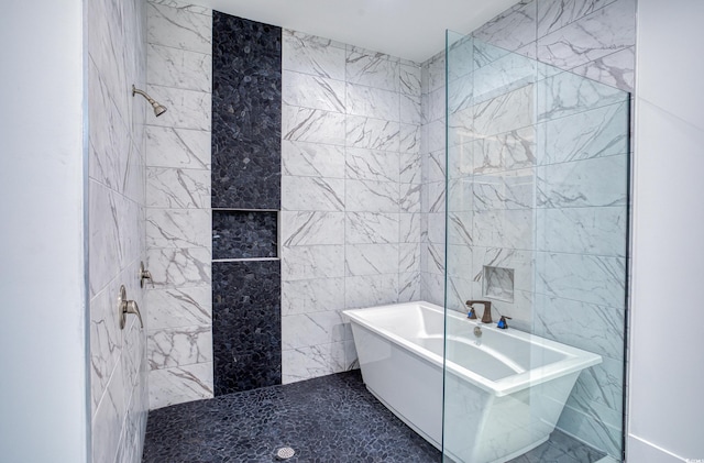 bathroom with a washtub and tile walls