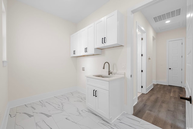 laundry room with baseboards, visible vents, hookup for a washing machine, marble finish floor, and a sink