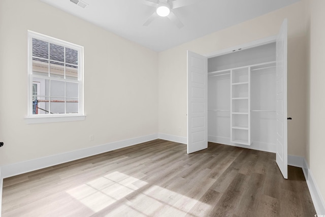 unfurnished bedroom with a closet, visible vents, light wood-style flooring, and baseboards