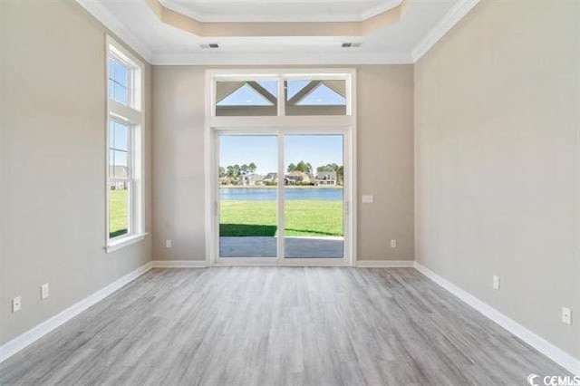 296 Starlit Way, Myrtle Beach, SC 29579 - spare room with a tray ceiling, crown molding, light wood-type flooring, a water view, and baseboards