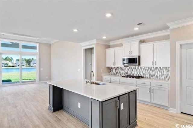 296 Starlit Way, Myrtle Beach, SC 29579 - kitchen with a sink, stainless steel appliances, crown molding, backsplash, and light countertops