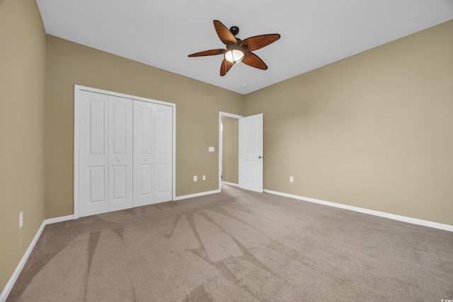 unfurnished bedroom with carpet flooring, ceiling fan, and a closet