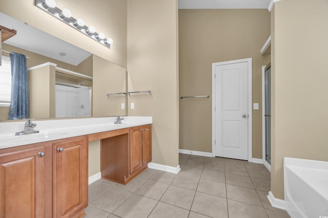 bathroom featuring double vanity, a bath, tile patterned flooring, a stall shower, and a sink
