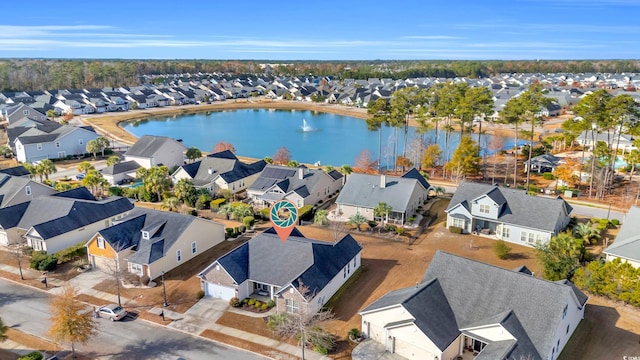 drone / aerial view featuring a residential view and a water view