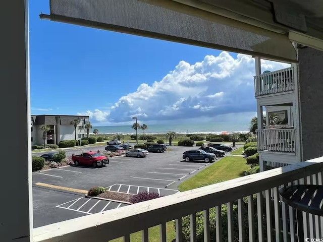 uncovered parking lot featuring a water view