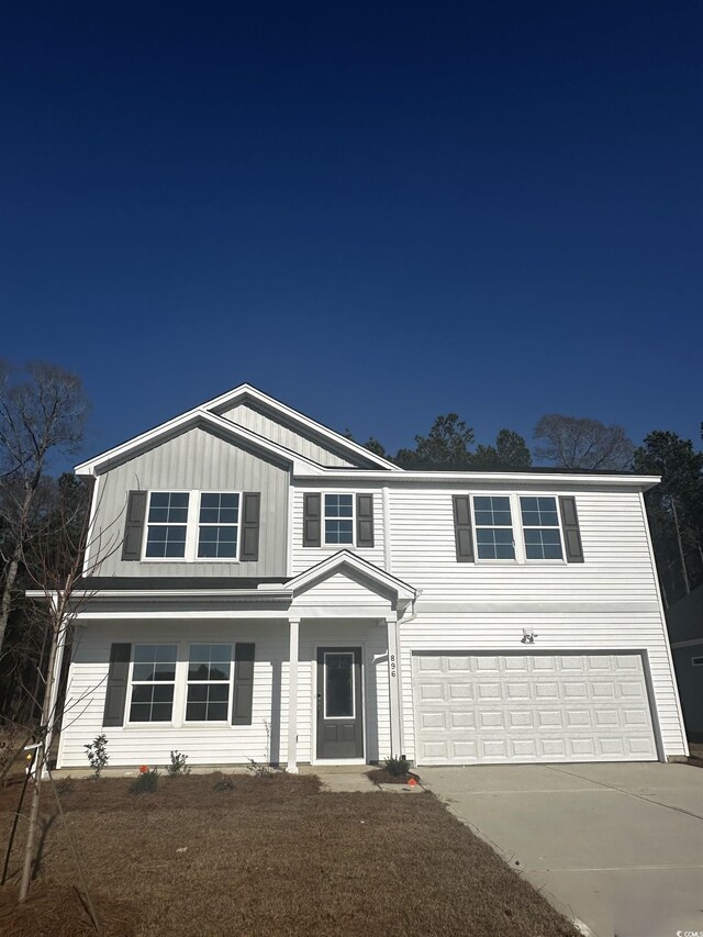 view of front of property featuring a front yard and a garage