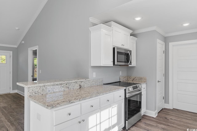 kitchen with appliances with stainless steel finishes, white cabinetry, lofted ceiling, dark hardwood / wood-style flooring, and kitchen peninsula