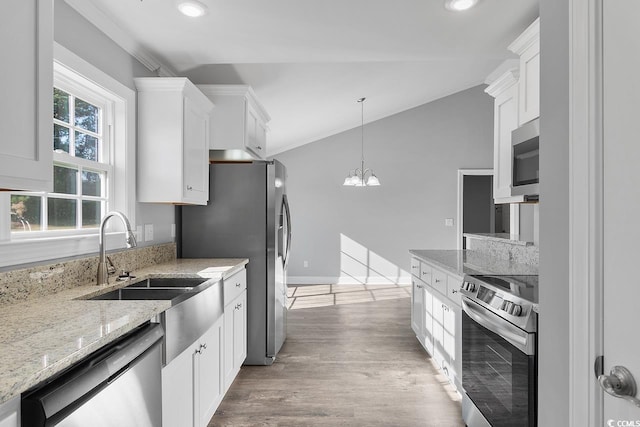 kitchen with pendant lighting, sink, stainless steel appliances, a notable chandelier, and white cabinets