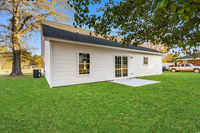 back of property with a yard, a patio area, and central air condition unit