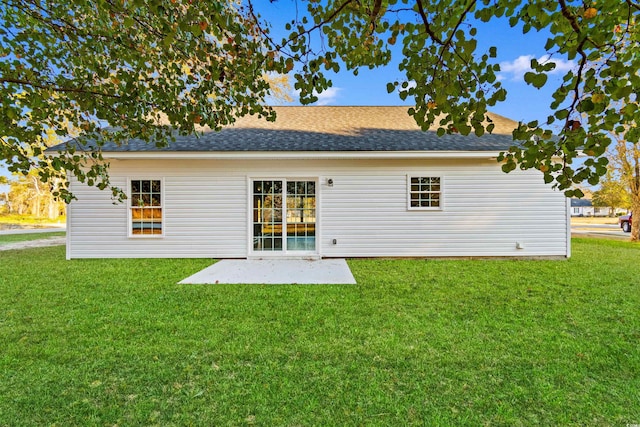 rear view of property with a yard and a patio area