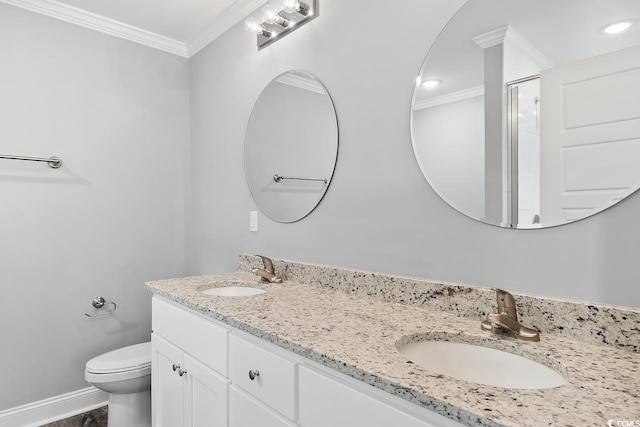 bathroom with vanity, a shower with door, ornamental molding, and toilet