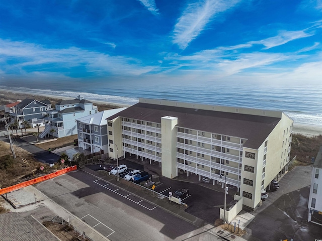 birds eye view of property with a beach view and a water view