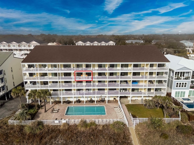 view of building exterior featuring a community pool