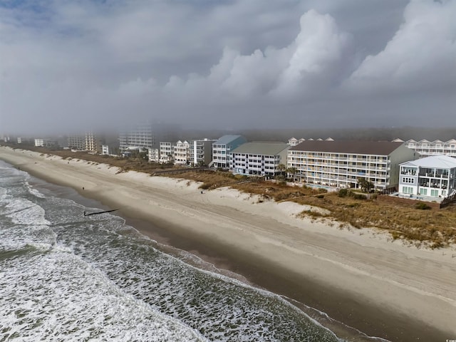 bird's eye view featuring a view of the beach and a water view