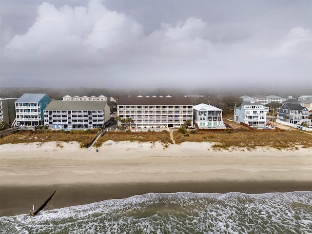 drone / aerial view with a water view and a beach view