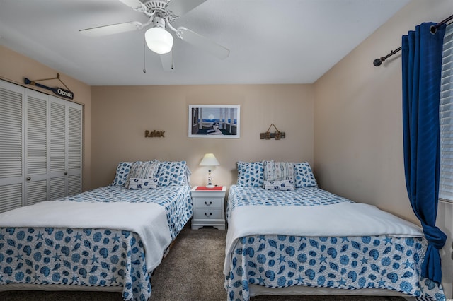 bedroom with ceiling fan, a closet, and dark colored carpet