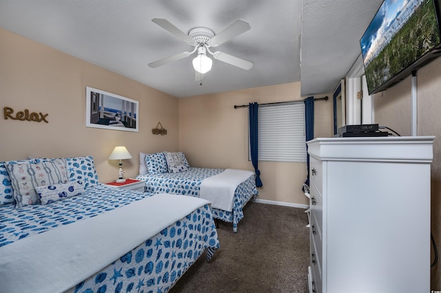 bedroom featuring ceiling fan and dark carpet