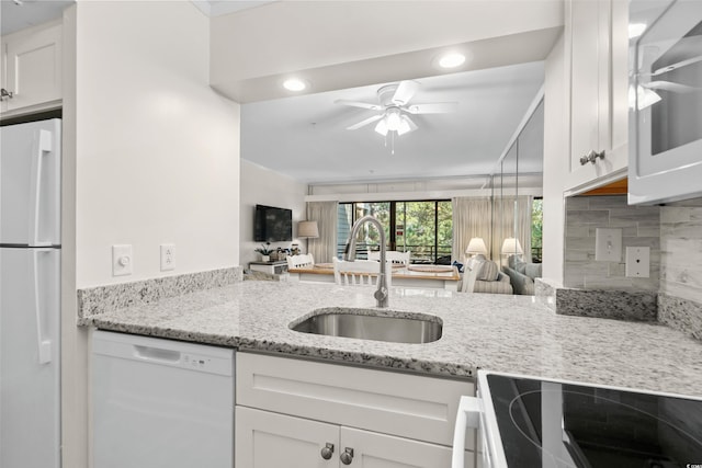 kitchen with white cabinets, white appliances, and sink