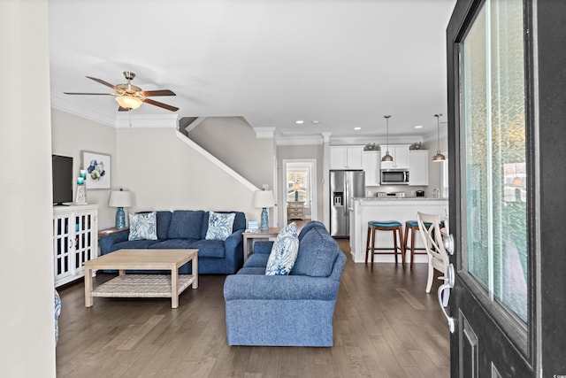 living room with ceiling fan, dark wood-type flooring, and ornamental molding