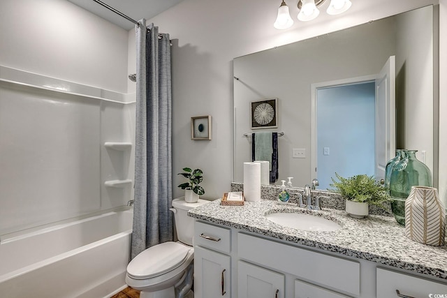 full bathroom with vanity, shower / tub combo with curtain, and toilet