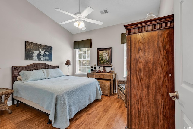 bedroom featuring ceiling fan, lofted ceiling, and light wood-type flooring