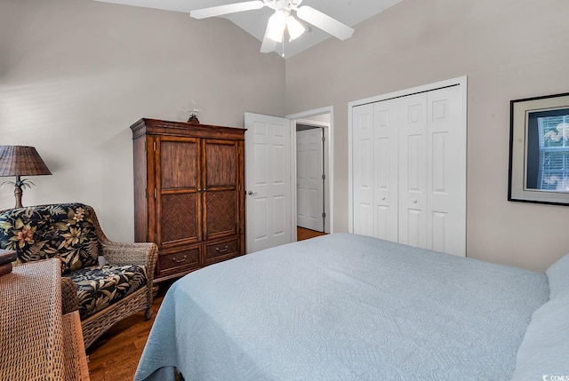 bedroom with ceiling fan, lofted ceiling, dark wood-type flooring, and a closet