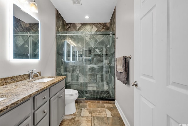 bathroom with vanity, an enclosed shower, and toilet