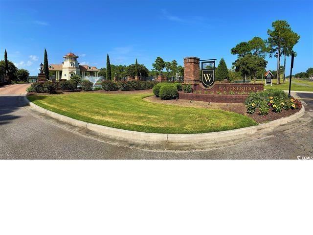 community sign featuring a yard