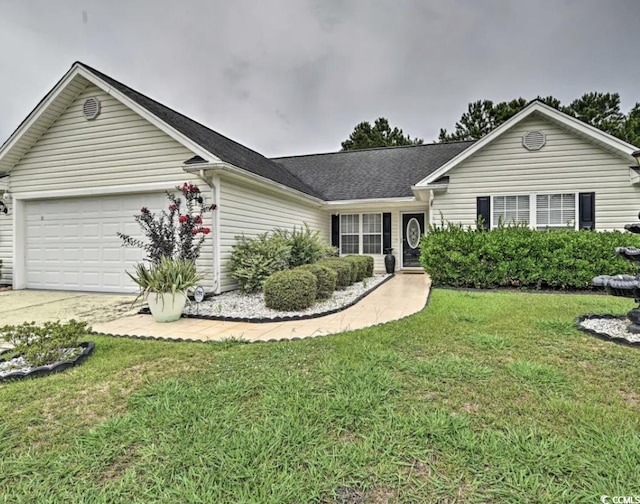 ranch-style home featuring a garage and a front lawn