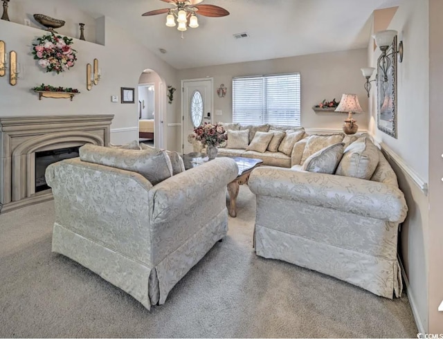 living room featuring lofted ceiling, light colored carpet, and ceiling fan