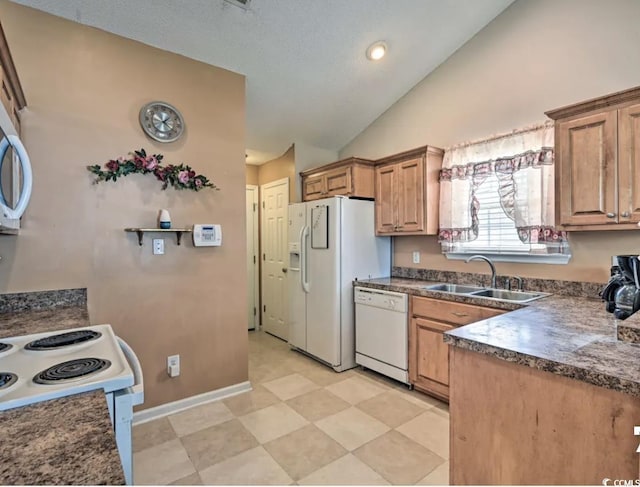 kitchen with sink, white appliances, and vaulted ceiling