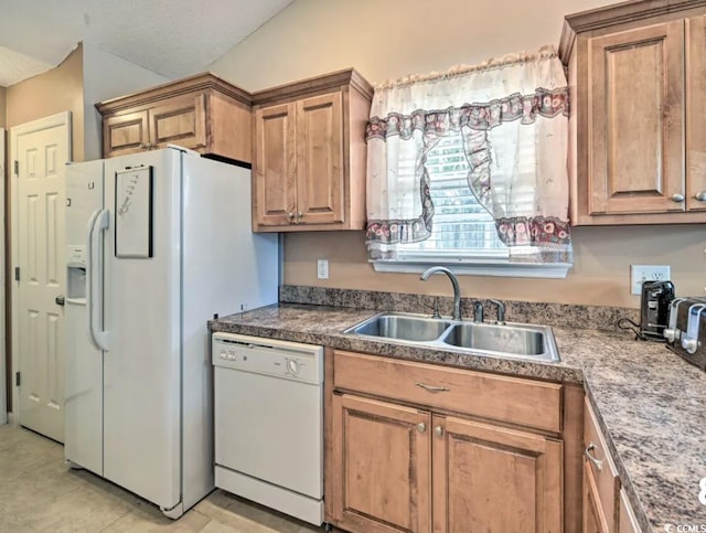 kitchen featuring white appliances, lofted ceiling, sink, and a textured ceiling