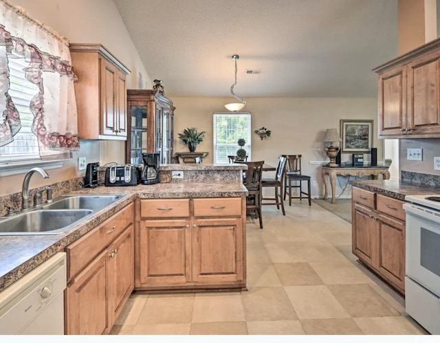 kitchen featuring vaulted ceiling, sink, white appliances, and decorative light fixtures