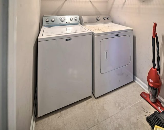 laundry area featuring independent washer and dryer and light tile patterned flooring