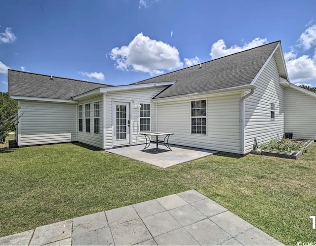 back of house with a patio area and a lawn