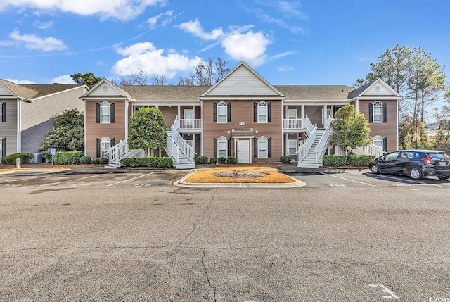 712 Algonquin Dr Unit A, Pawleys Island, SC 29585 - view of property with stairway, uncovered parking, and a porch