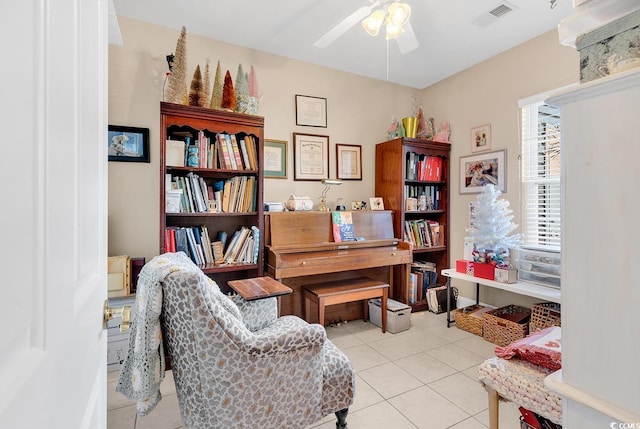 interior space with light tile patterned floors and ceiling fan